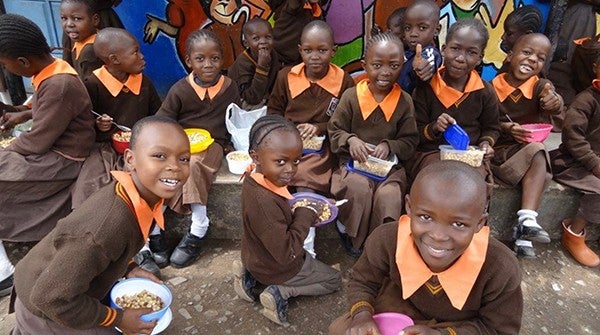 給食を手に笑顔の子どもたち